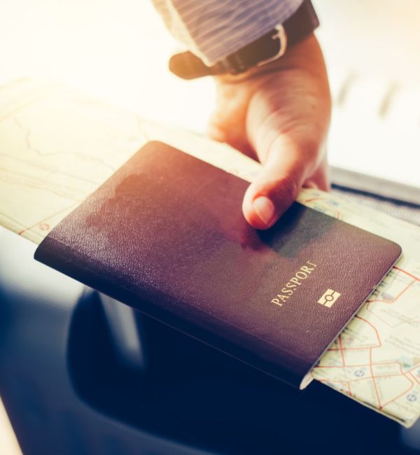 A person holding a passport and suitcase, applying for Express Entry.