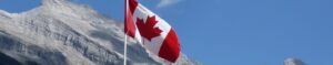 Canadian flag waving majestically with a mountainous landscape in the background, capturing the essence of the Canadian Dream.